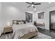 Well lit bedroom featuring neutral colors, a ceiling fan, and black framed windows at 29501 N 76Th St, Scottsdale, AZ 85266