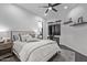 Well-lit bedroom featuring a ceiling fan, a comfortable bed, and a desk area with natural light at 29501 N 76Th St, Scottsdale, AZ 85266