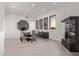 An elegant dining room boasts modern decor, unique lighting, and a stylish octagonal mirror at 29501 N 76Th St, Scottsdale, AZ 85266