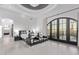 The main bedroom has a tray ceiling, a chandelier, and a sitting area with plush chairs at 29501 N 76Th St, Scottsdale, AZ 85266