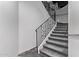 Carpeted staircase with decorative wrought iron railing leading upwards at 29501 N 76Th St, Scottsdale, AZ 85266