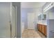 Bathroom with a shower and tub combo, single sink vanity, and neutral tile floors at 3102 W T Ryan Ln, Phoenix, AZ 85041