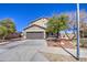 Inviting two-story home with a spacious driveway, mature trees, and a well-kept lawn at 3102 W T Ryan Ln, Phoenix, AZ 85041