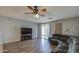 Cozy living room with a large sectional sofa, ceiling fan, and sliding glass door at 3102 W T Ryan Ln, Phoenix, AZ 85041