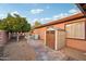 Backyard view of storage shed, fruit tree, and partial pool view at 3482 E Cotton Ln, Gilbert, AZ 85234