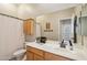 Bathroom with wooden vanity and a large mirror reflecting doorway views at 3482 E Cotton Ln, Gilbert, AZ 85234