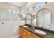 Bathroom featuring double sinks, granite countertops, and a glass-enclosed shower with natural light at 3482 E Cotton Ln, Gilbert, AZ 85234