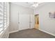 Bedroom with neutral carpet, closet, and view to ensuite bathroom at 3482 E Cotton Ln, Gilbert, AZ 85234