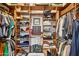 Organized walk-in closet with custom shelving and hanging space for clothes and accessories at 3482 E Cotton Ln, Gilbert, AZ 85234