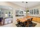 Cozy dining area with wooden table, chairs, and an open view to the living room and backyard at 3482 E Cotton Ln, Gilbert, AZ 85234