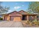 Charming single-story home featuring a three-car garage, desert landscaping, and a welcoming front entrance at 3482 E Cotton Ln, Gilbert, AZ 85234