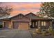 Inviting home featuring a three-car garage, a basketball hoop, and landscaped front yard at 3482 E Cotton Ln, Gilbert, AZ 85234