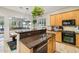 Well-lit kitchen with wooden cabinets, granite countertops, and black appliances for a modern feel at 3482 E Cotton Ln, Gilbert, AZ 85234