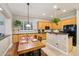 Eat-in kitchen features wood cabinetry, tiled countertops, black appliances, and a center island at 3482 E Cotton Ln, Gilbert, AZ 85234