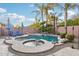 The backyard showcases a sparkling pool, spa, lounge chairs, and swaying palm trees at 3482 E Cotton Ln, Gilbert, AZ 85234