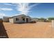 Expansive backyard with tan rock and block fence, offering plenty of space for outdoor activities at 35680 W Mallorca Ave, Maricopa, AZ 85138