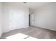 Bedroom featuring neutral walls, carpeted floors, closet with sliding doors, and a doorway at 35680 W Mallorca Ave, Maricopa, AZ 85138