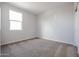 Bedroom featuring neutral walls, carpeted floors, a window providing natural light, and a closet at 35680 W Mallorca Ave, Maricopa, AZ 85138