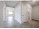 Hallway featuring neutral walls and tile floors, with doorways leading to other rooms at 35680 W Mallorca Ave, Maricopa, AZ 85138