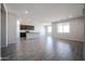 Spacious living area showing an open floorplan leading to the kitchen at 35680 W Mallorca Ave, Maricopa, AZ 85138