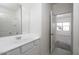 Clean, modern bathroom with white vanity and a view into an adjacent bedroom at 3983 E San Jose St, San Tan Valley, AZ 85143