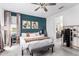 Well-appointed bedroom featuring an accent wall, natural light, plush carpet, and modern furnishings at 40160 W Hensley Way, Maricopa, AZ 85138