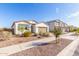 Well-maintained single-story home with desert landscaping and a paved driveway at 40160 W Hensley Way, Maricopa, AZ 85138