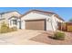 Well-maintained single-story home with desert landscaping and a paved driveway at 40160 W Hensley Way, Maricopa, AZ 85138