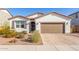 Charming single-story home showcasing desert landscaping and a paved driveway at 40160 W Hensley Way, Maricopa, AZ 85138