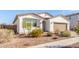 Charming single-story home showcasing desert landscaping and a paved driveway at 40160 W Hensley Way, Maricopa, AZ 85138