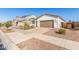 Well-maintained single-story home with desert landscaping and a paved driveway at 40160 W Hensley Way, Maricopa, AZ 85138