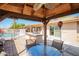 Inviting covered back patio with barbecue, table and chairs overlooking a sparkling pool at 4111 W Hayward Ave, Phoenix, AZ 85051