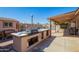 Outdoor kitchen and grill area, perfect for entertaining in the backyard at 4111 W Hayward Ave, Phoenix, AZ 85051