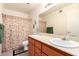 Bathroom features double sinks with orange cabinets and shower tub at 4111 W Hayward Ave, Phoenix, AZ 85051