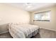 Bright bedroom features a ceiling fan and window with a view of a palm tree at 4111 W Hayward Ave, Phoenix, AZ 85051