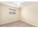 Clean and modern bedroom with light-colored walls and modern grey flooring at 4111 W Hayward Ave, Phoenix, AZ 85051