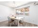 Cozy dining area features a white table set with seating for four, bathed in natural light at 4111 W Hayward Ave, Phoenix, AZ 85051