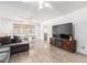 Open-concept living room with wood floors and a view of the adjacent dining area at 4111 W Hayward Ave, Phoenix, AZ 85051