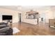 Inviting living space with a view into the kitchen, featuring modern appliances and wood floors at 4111 W Hayward Ave, Phoenix, AZ 85051