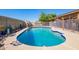 Refreshing swimming pool with mature landscaping surrounded by desert plants at 4111 W Hayward Ave, Phoenix, AZ 85051