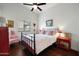 Bright bedroom featuring dark wood floors, a ceiling fan, and cheerful red accent furniture at 449 E Fred Ave, Apache Junction, AZ 85119