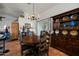 Dining room featuring a wooden table, hutch, and terracotta tile flooring at 449 E Fred Ave, Apache Junction, AZ 85119