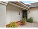 Cozy front porch with textured walls, tiled flooring, and a wrought-iron gate at 449 E Fred Ave, Apache Junction, AZ 85119