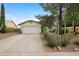 Inviting single-story home features a two-car garage, desert landscaping, and a well-maintained front yard at 449 E Fred Ave, Apache Junction, AZ 85119