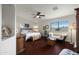 Cozy main bedroom with wood floors, ceiling fan, and seating area at 449 E Fred Ave, Apache Junction, AZ 85119