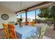 Covered patio area with colorful dining set and gravel yard, perfect for outdoor entertaining at 449 E Fred Ave, Apache Junction, AZ 85119