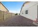 Wide gravel side yard with block wall, connecting the front and back of the property at 449 E Fred Ave, Apache Junction, AZ 85119