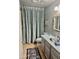 Cozy bathroom featuring patterned shower curtain, tiled floor, and single sink at 4800 N 68Th St # 104, Scottsdale, AZ 85251