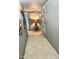 Well-lit hallway with tile flooring, neutral wall paint, and stylish decorative artwork at 4800 N 68Th St # 104, Scottsdale, AZ 85251