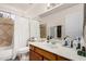 Bathroom featuring a bath tub with shower and a vanity with white countertops at 4931 E Paradise Ln, Scottsdale, AZ 85254